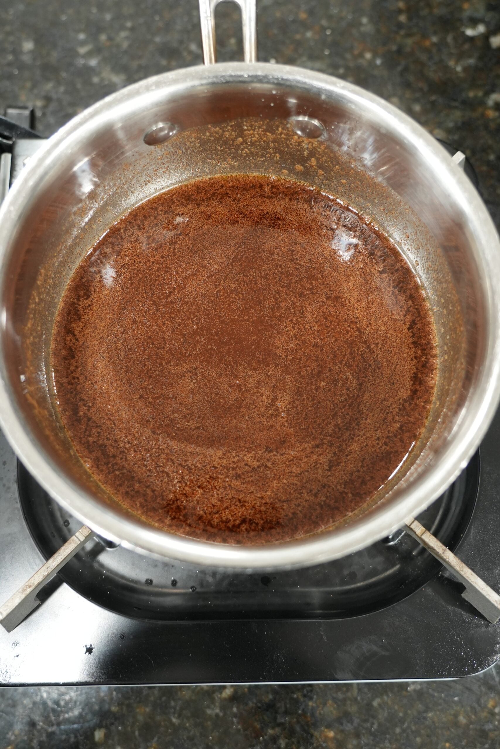 Cinnamon roll bread pudding soaking in custard before baking