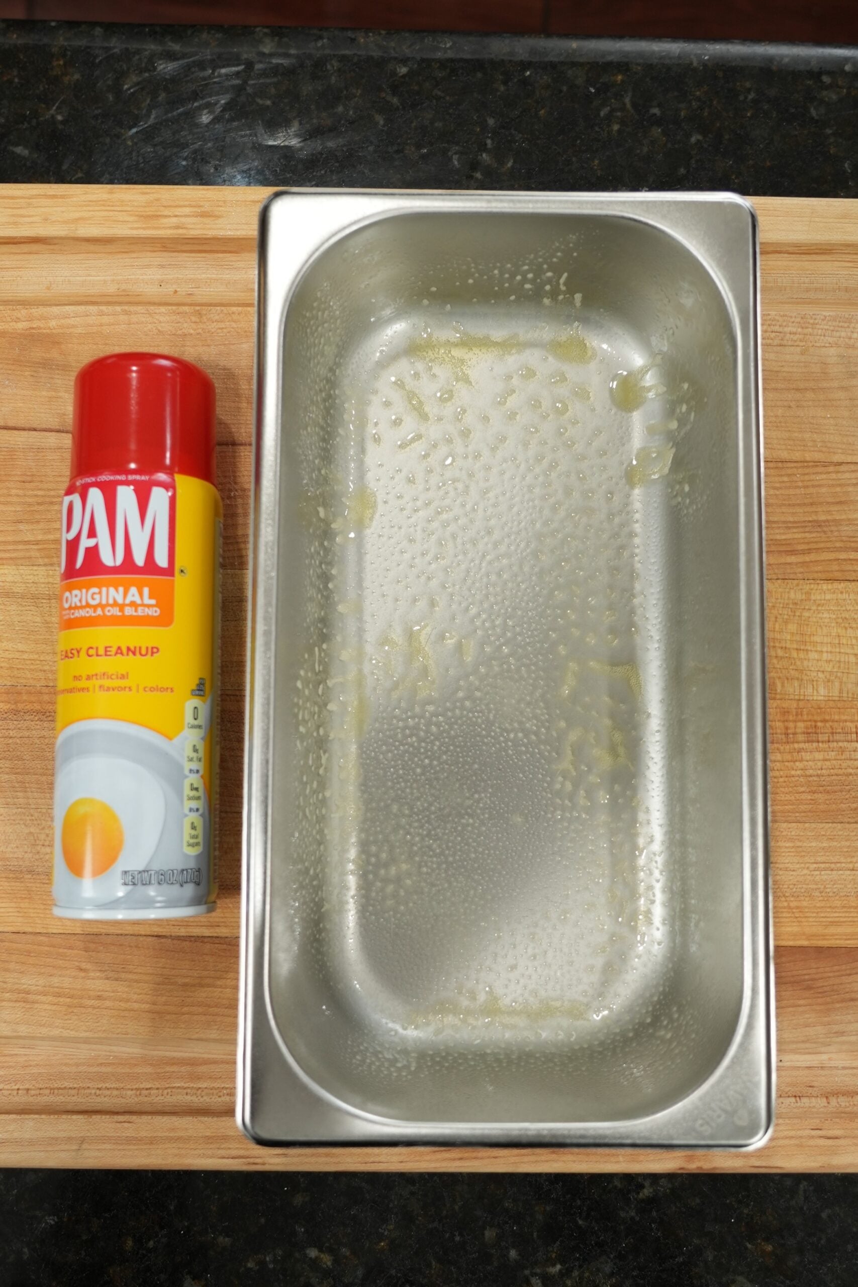 Drizzling cream cheese icing over the warm cinnamon roll bread pudding