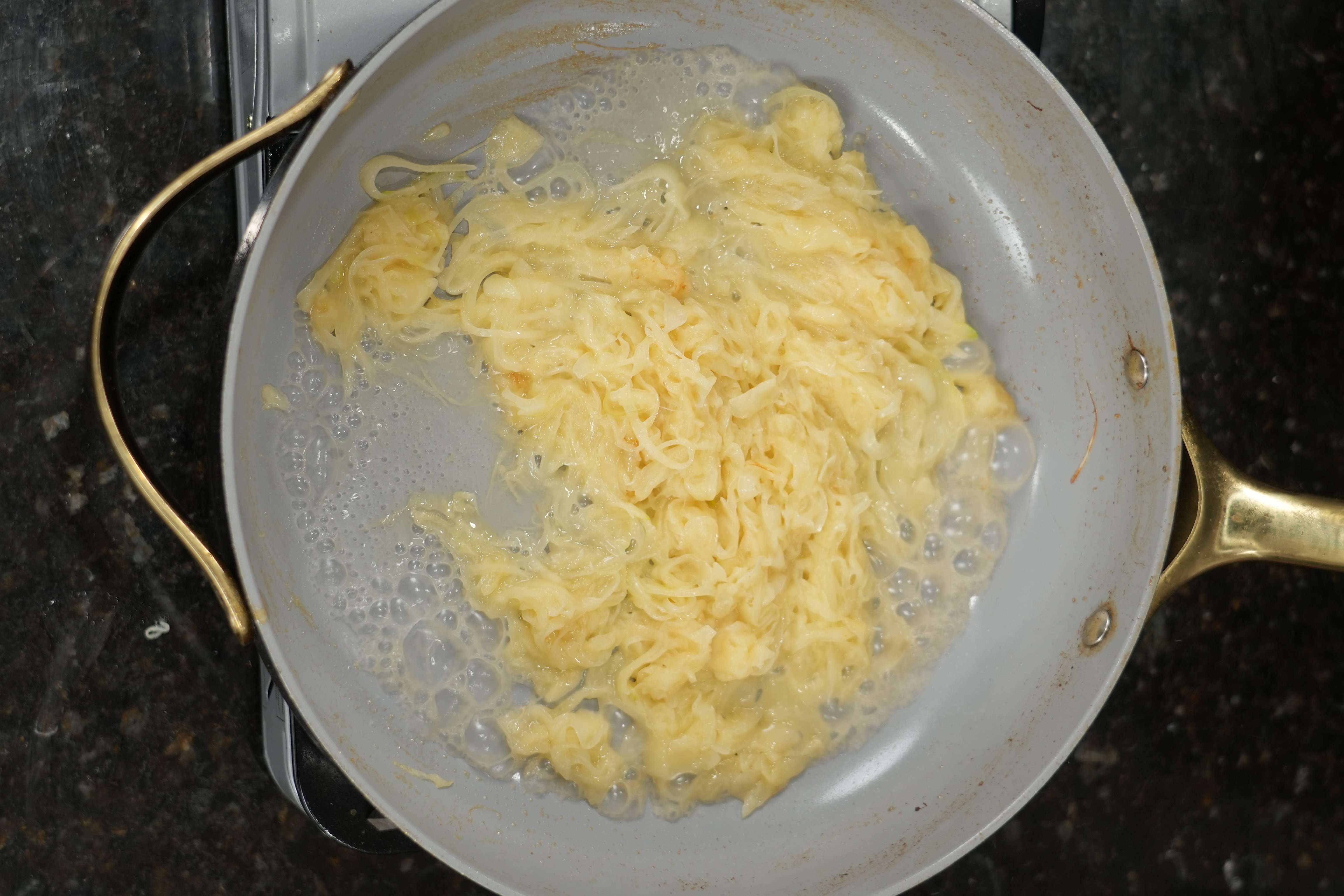 Building the cream sauce with parmesan for caramelized onion pasta