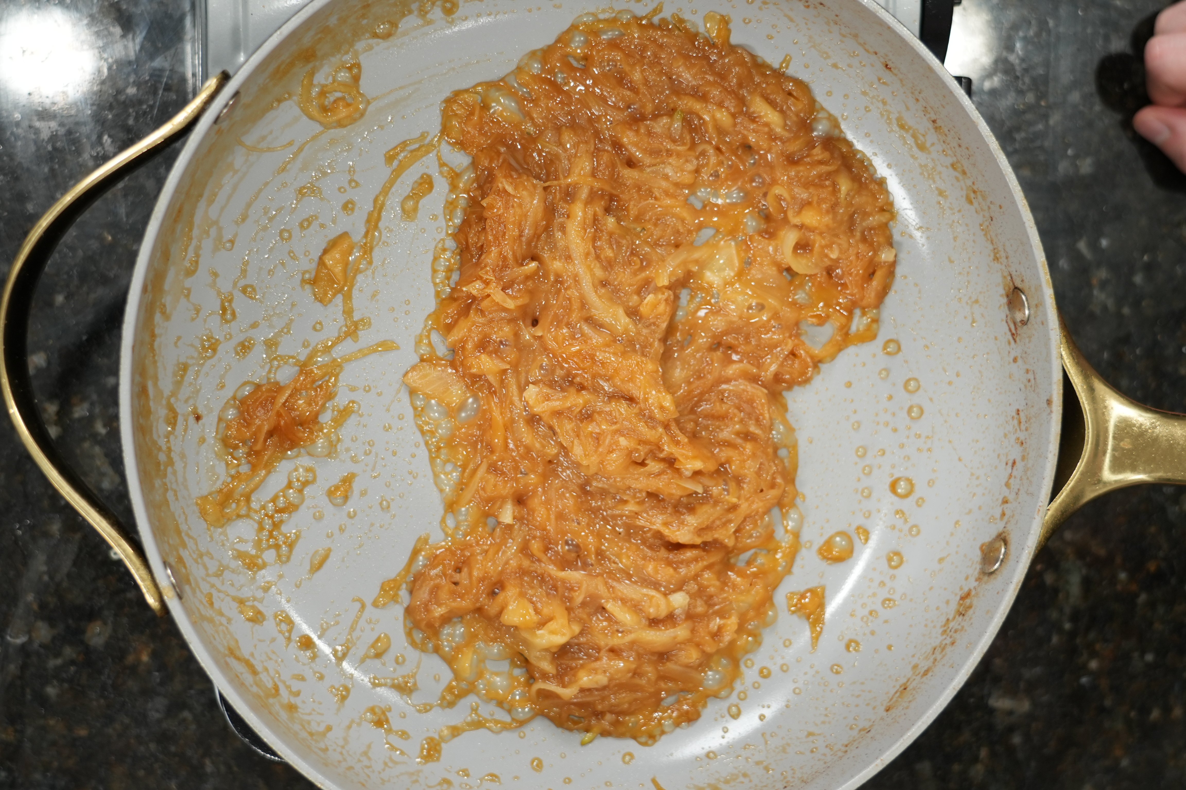Salmon fillet searing in a hot pan with honey soy glaze