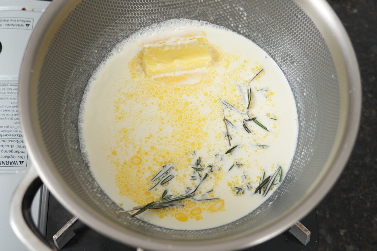 Butter and fresh rosemary melting in a pot for shepherd's pie mashed potato topping