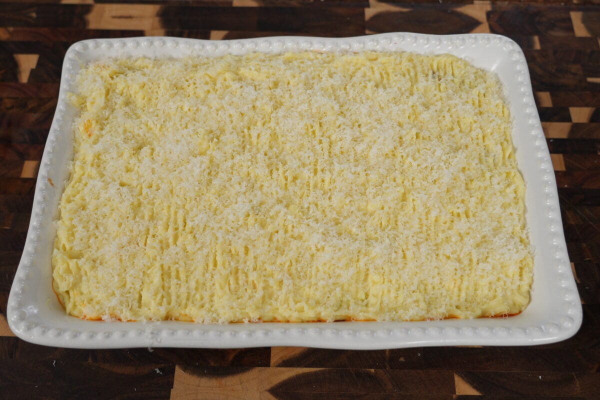 Savory meat filling with vegetables simmering in a skillet for shepherd's pie recipe