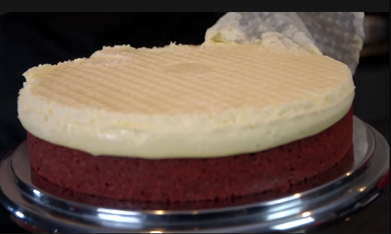 Cream cheese frosting on red velvet cheesecake
