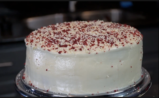 Finished red velvet cheesecake with white chocolate garnish