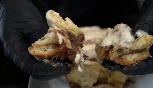 Maple cream cheese frosting on warm cinnamon rolls