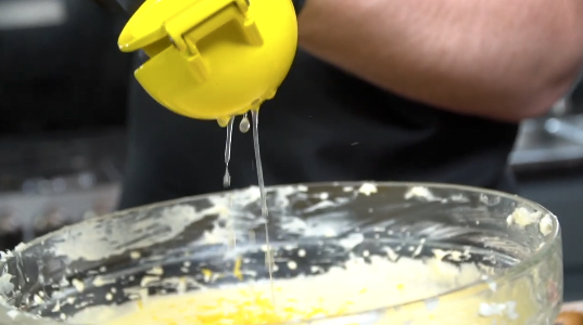 Adding eggs one at a time to pound cake batter