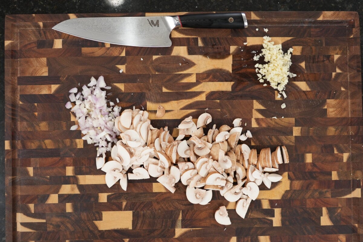 Prepped cremini mushrooms, shallots, and garlic ready for Steak Diane