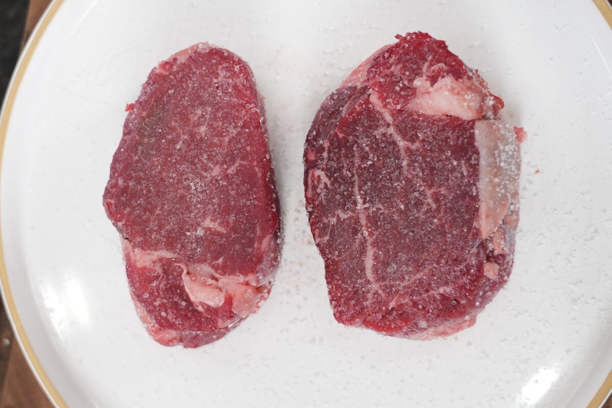 Filet mignon steaks generously seasoned with kosher salt before searing