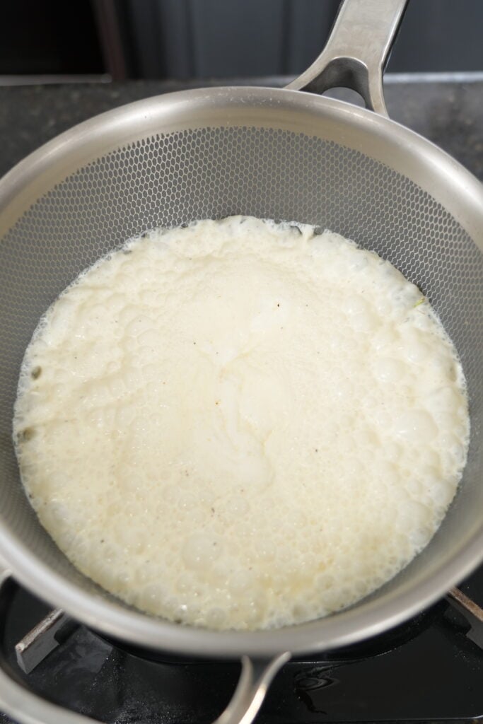 Rosemary-infused cream strained and ready for the Steak Diane pan sauce