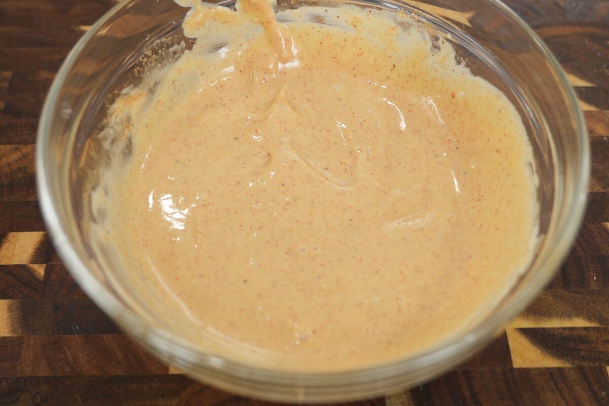 assembling sliders on Hawaiian rolls with cheese and meat filling