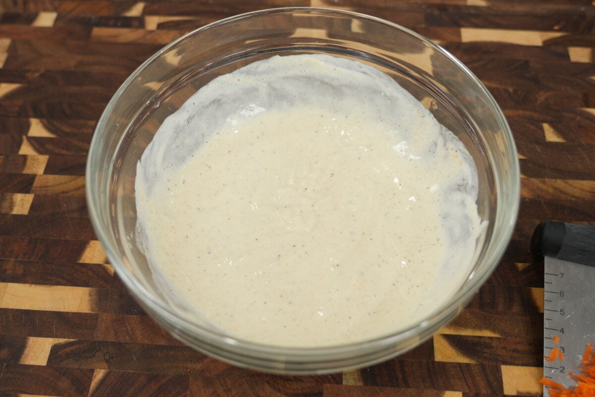 mixing creamy coleslaw dressing with apple cider vinegar and AP seasoning