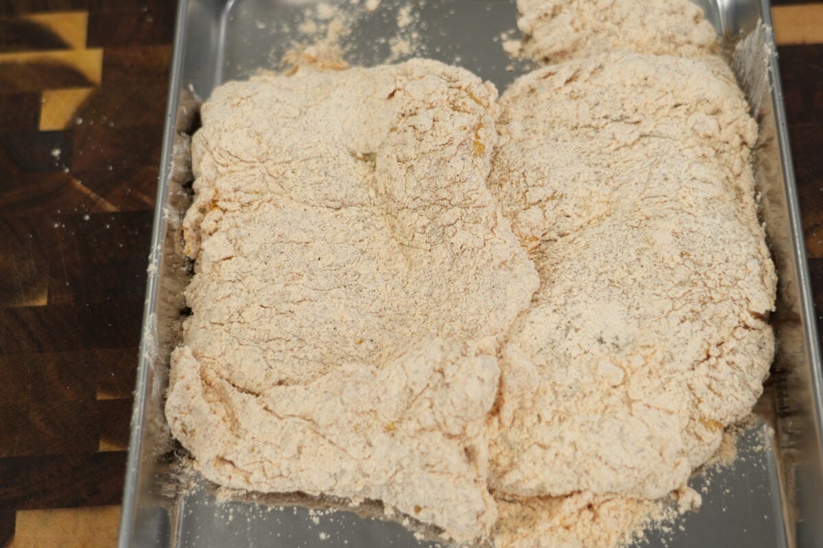 assembling hot honey chicken sandwich with slaw on brioche bun