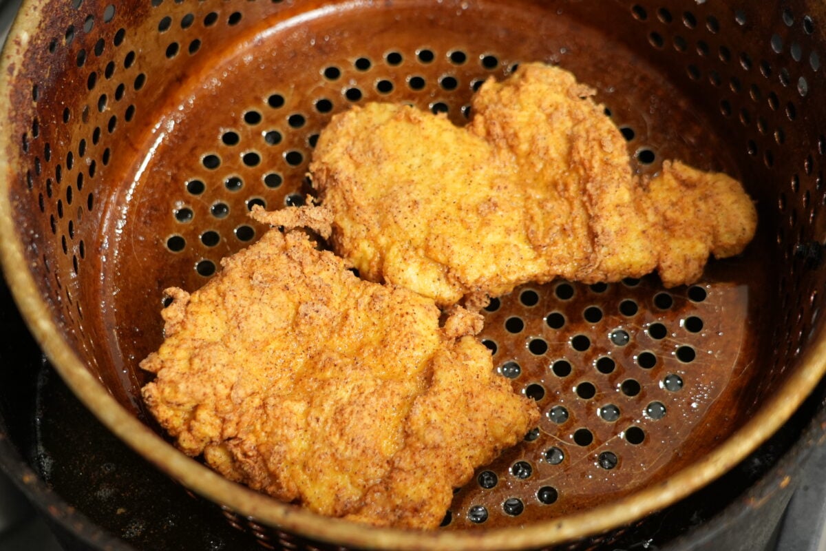 close up of crispy hot honey chicken sandwich cut in half