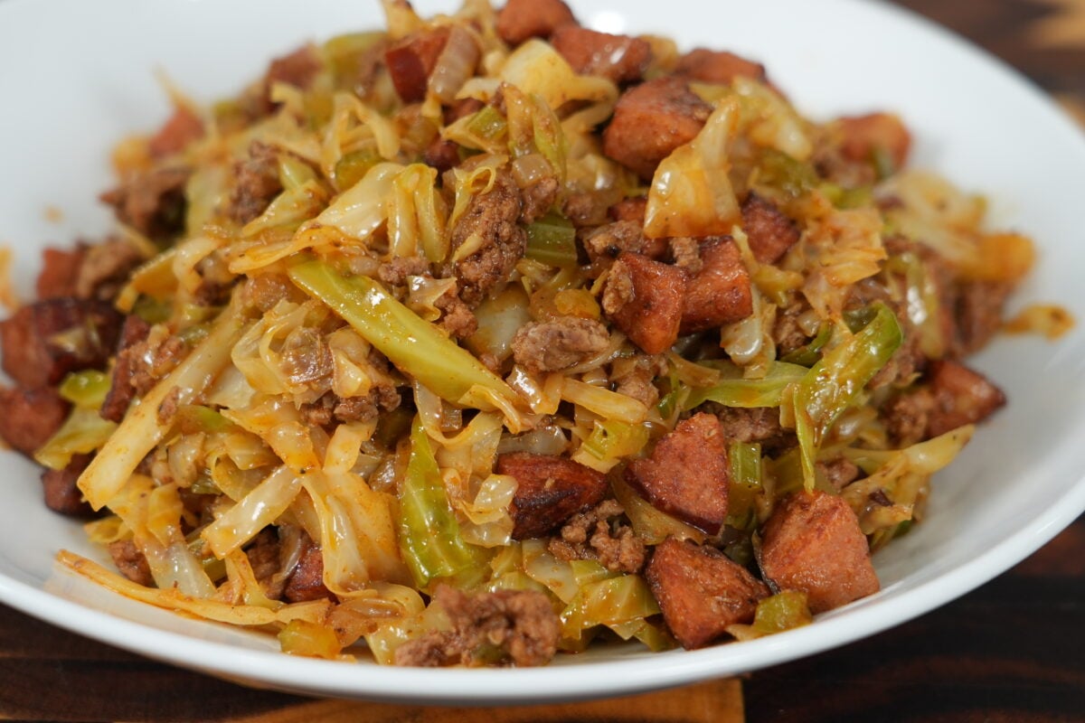 Dirty cabbage in a cast iron skillet — Cajun fried cabbage with ground beef and andouille sausage