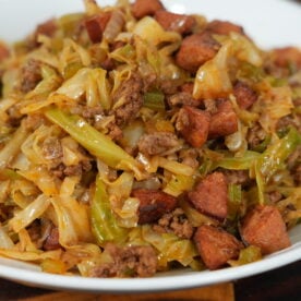 Dirty cabbage in a cast iron skillet — Cajun fried cabbage with ground beef and andouille sausage