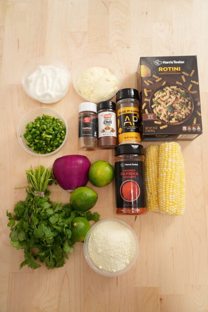 Charred corn, cotija, lime, jalapeño, rotini, and cilantro ingredients for pasta salad