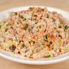 Elote pasta salad plated and garnished with cotija and cilantro