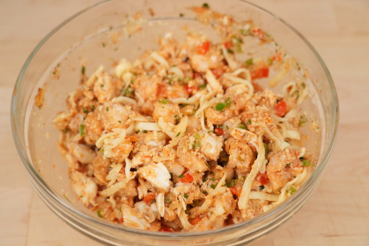 Seafood stuffed shells arranged in Cajun cream sauce before baking