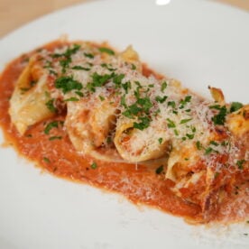 Seafood stuffed shells baked in creamy Cajun sauce, bubbling and garnished with parsley