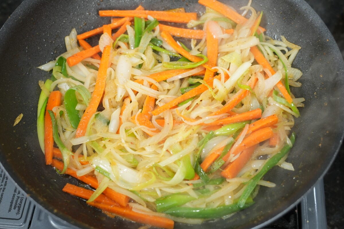 Carrots, onion and green onion softening in a nonstick skillet