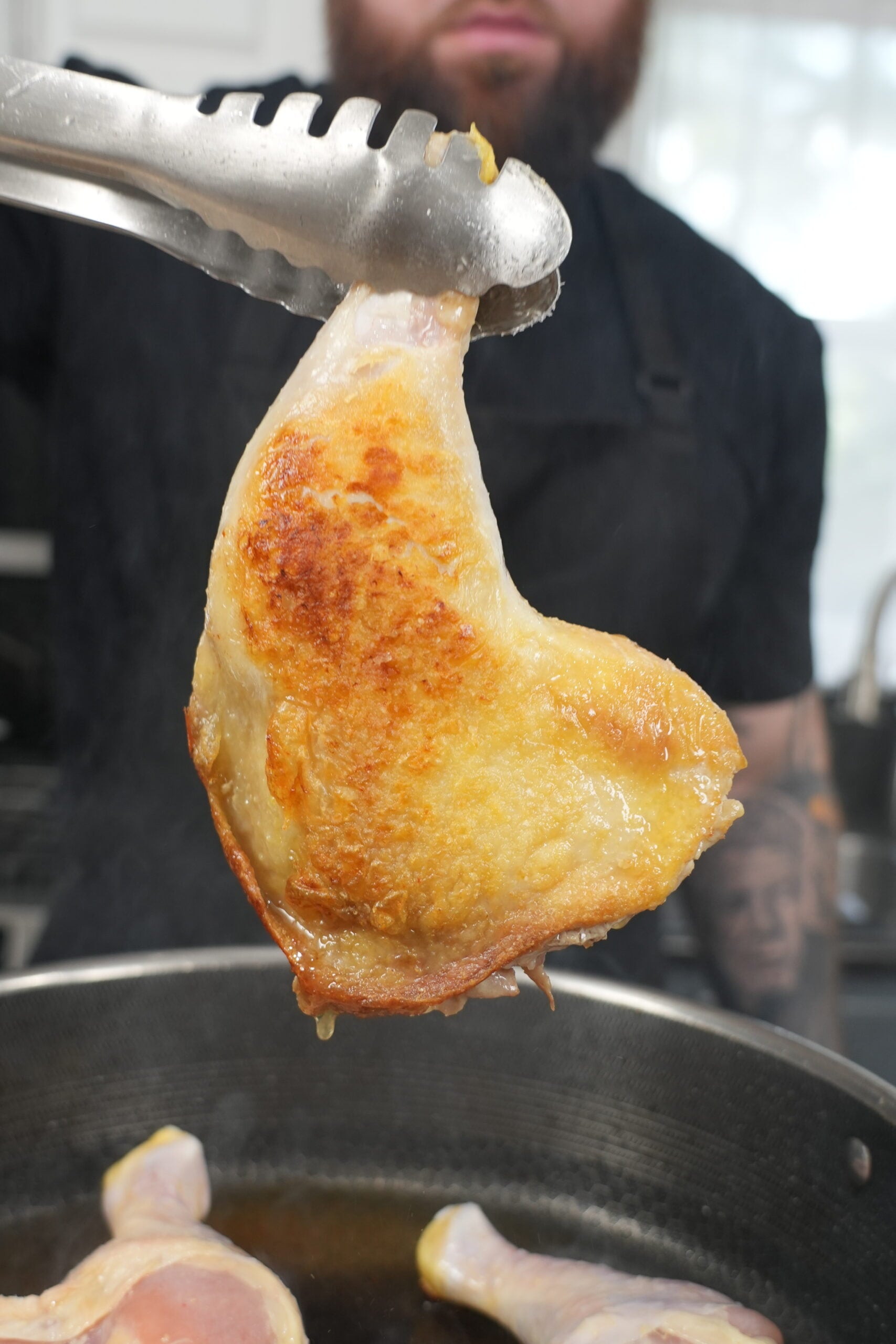 Golden-brown chicken leg quarter seared until the skin is crispy