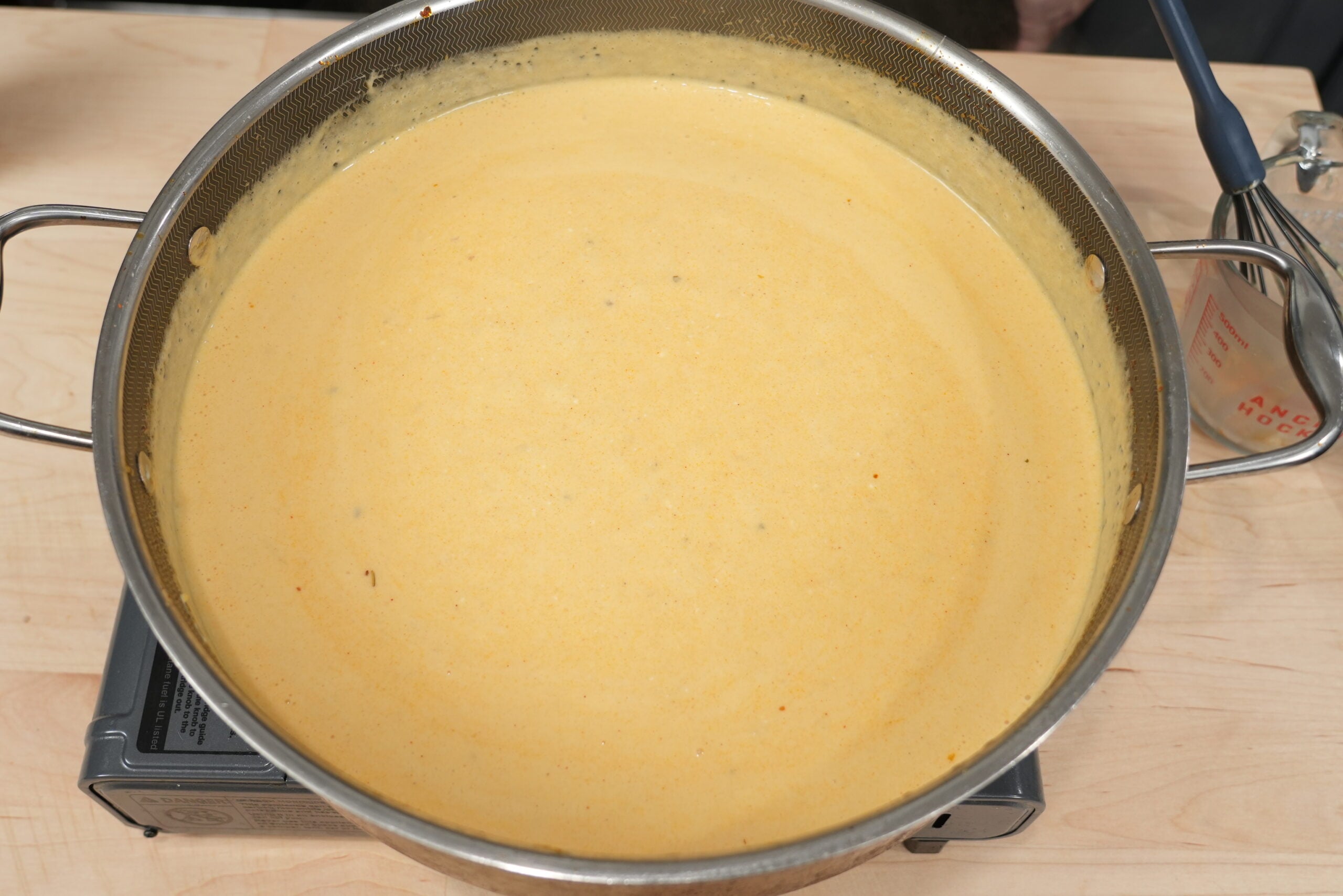 Creamy four-cheese queso sauce in a skillet
