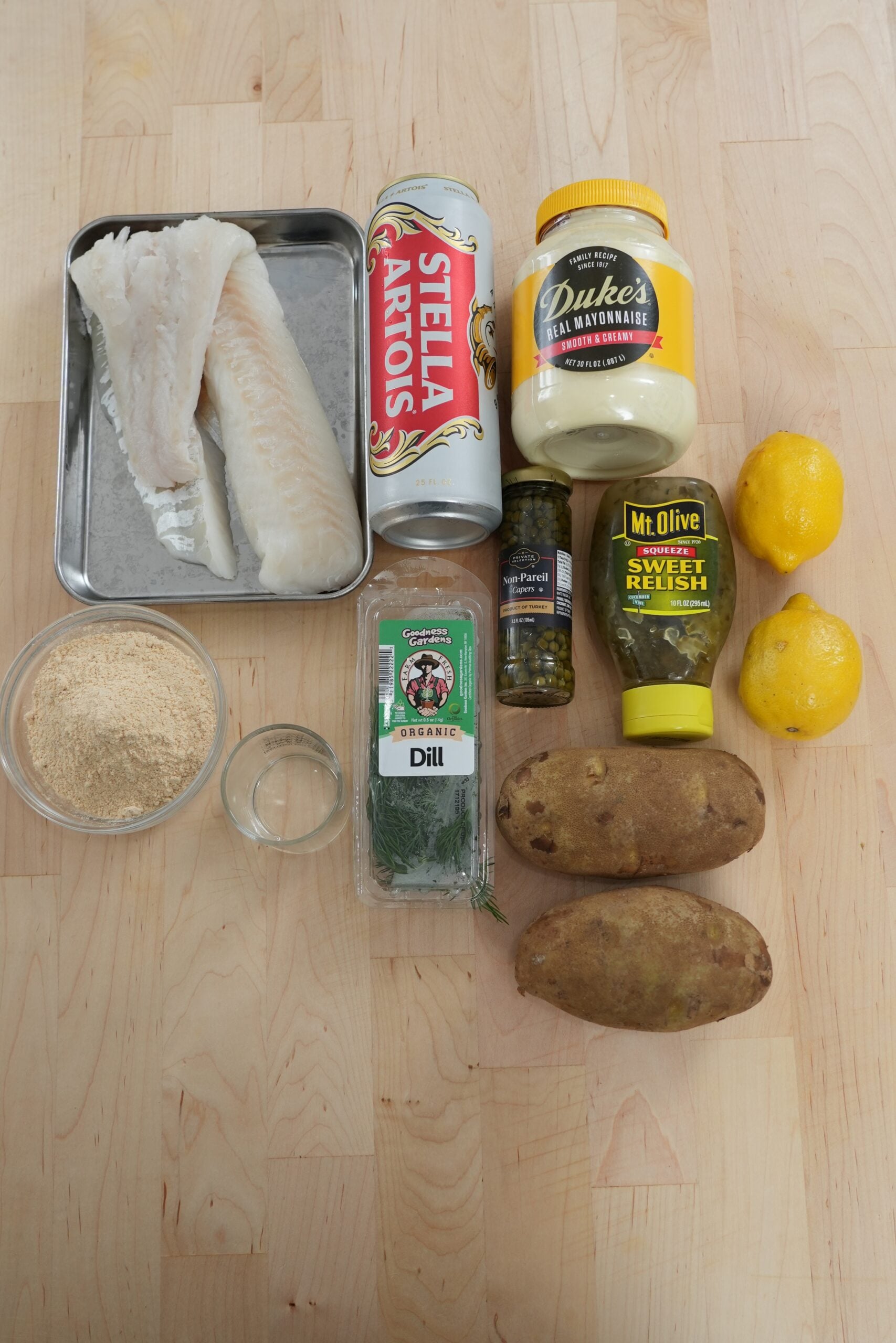 Cod, potatoes, beer and tartar sauce ingredients for fish and chips
