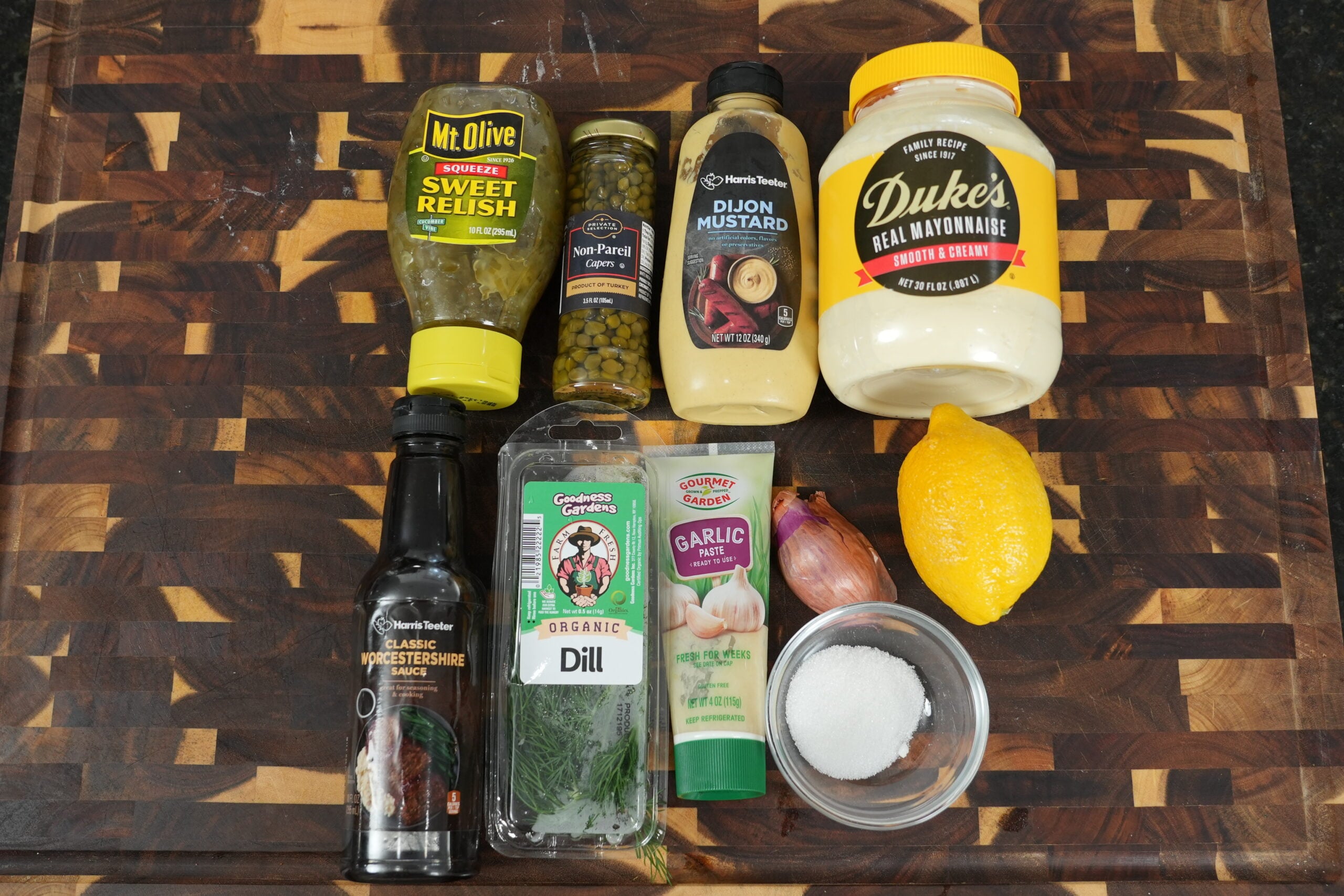 Homemade tartar sauce ingredients with mayonnaise, dill, capers and lemon