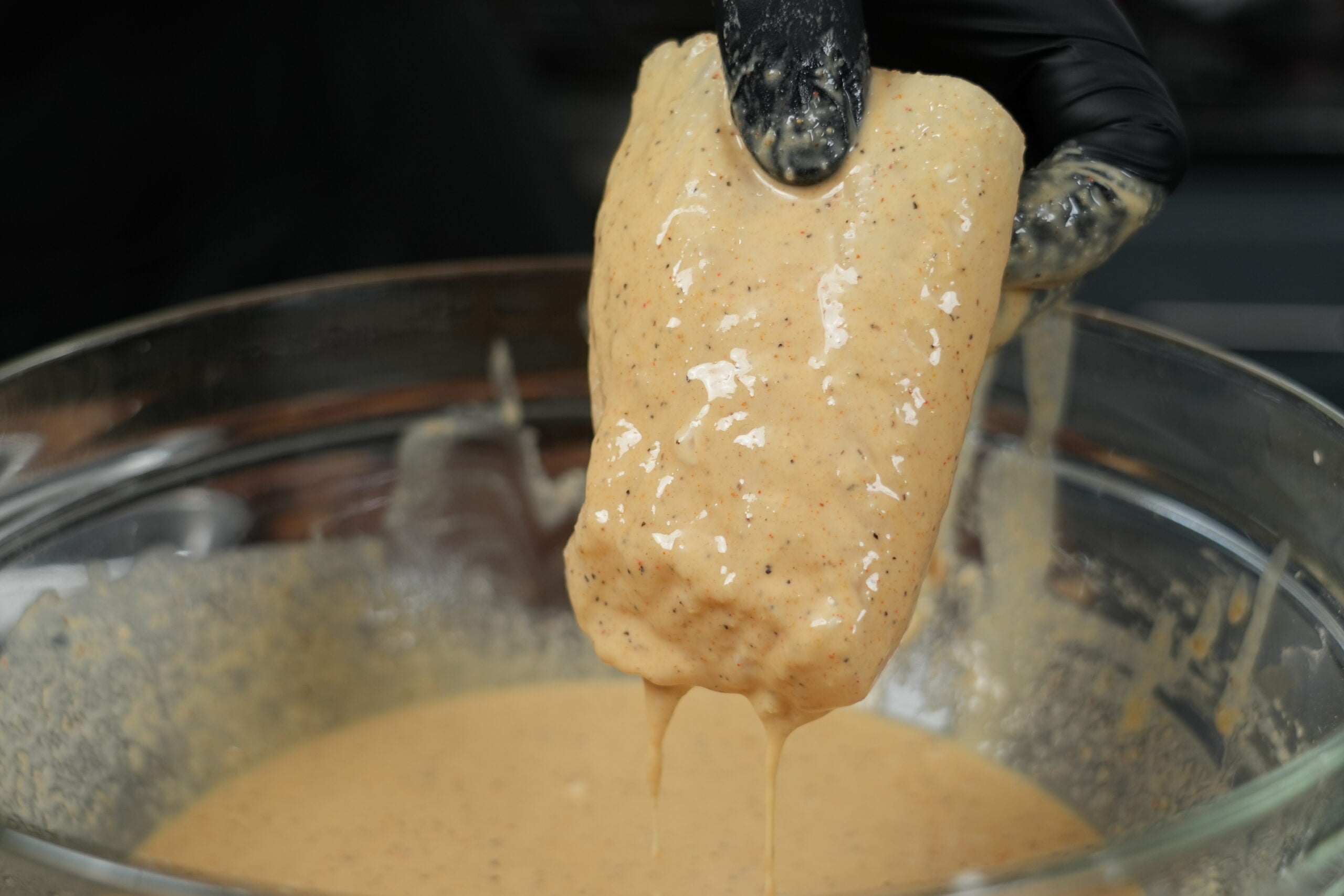 Cod fillet coated in beer batter before frying