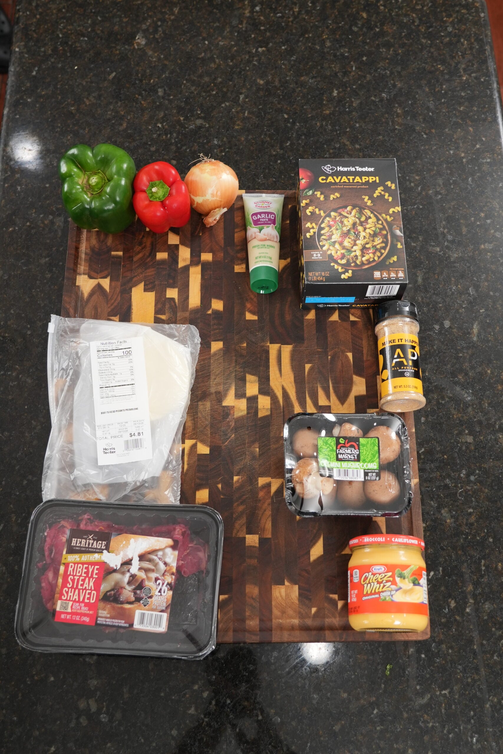 Ingredients for Philly cheesesteak helper arranged on a board