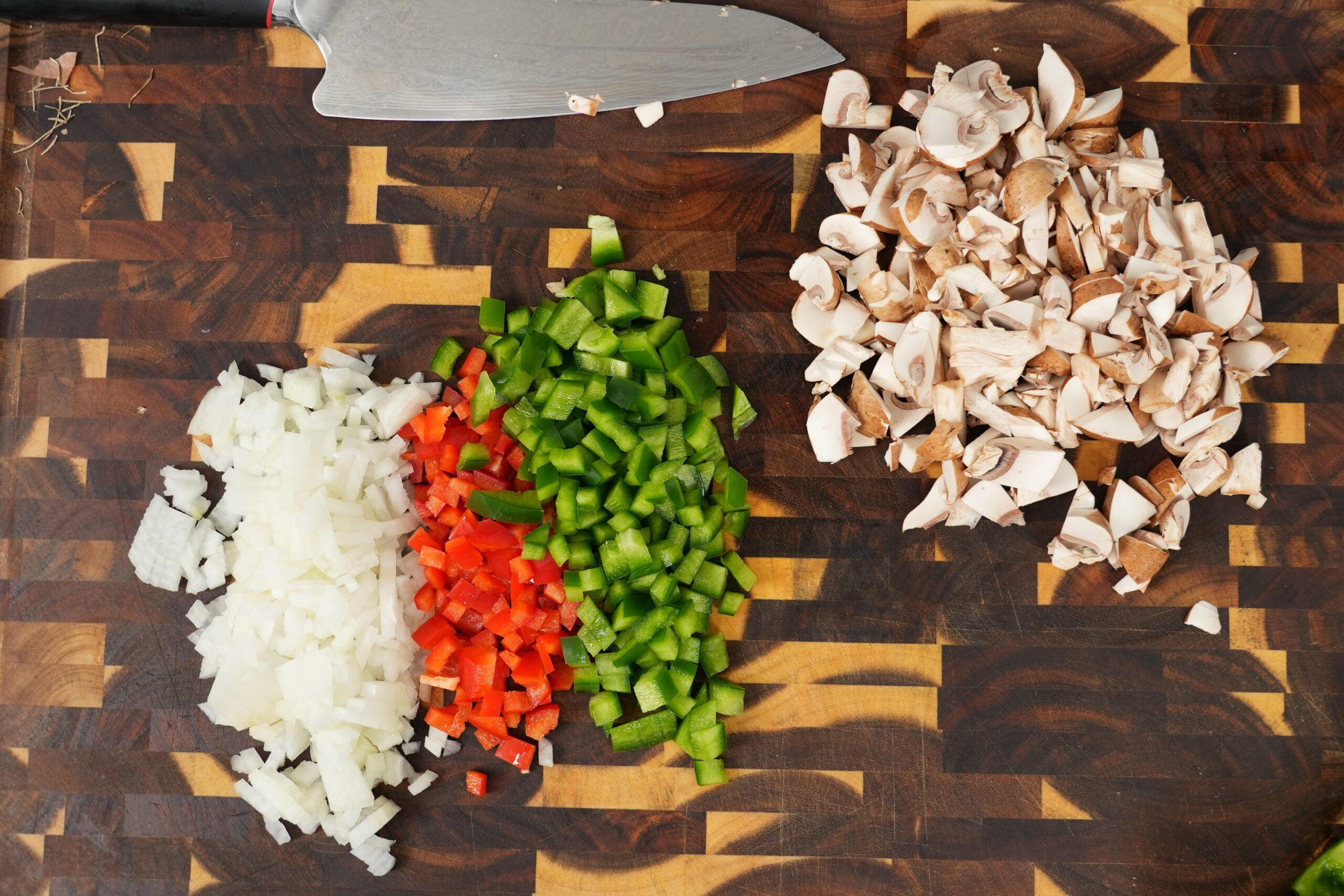 Diced onion, green and red bell peppers, and mushrooms for the pasta