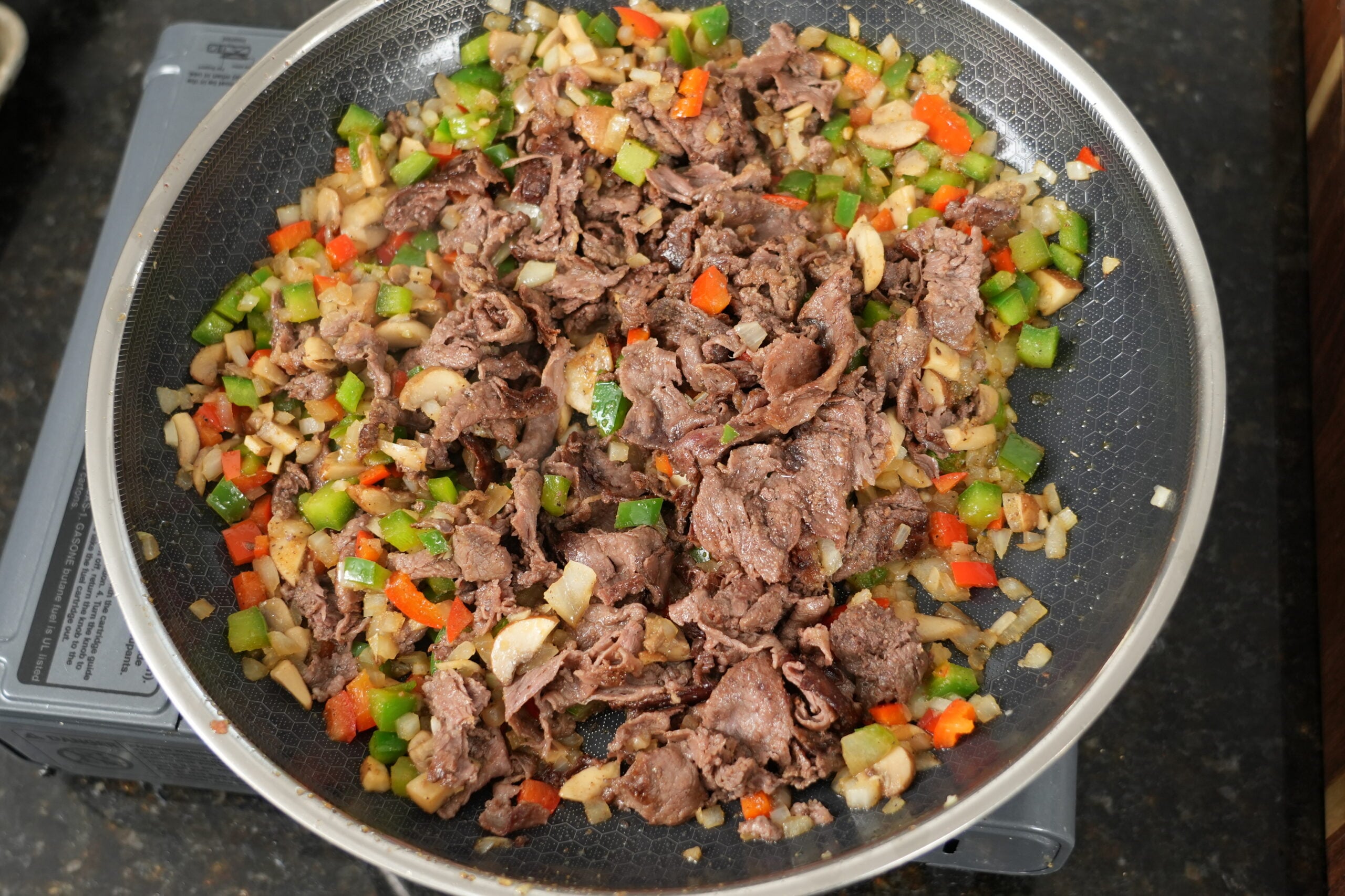 Seared ribeye mixed with sauteed peppers, onion, and mushrooms
