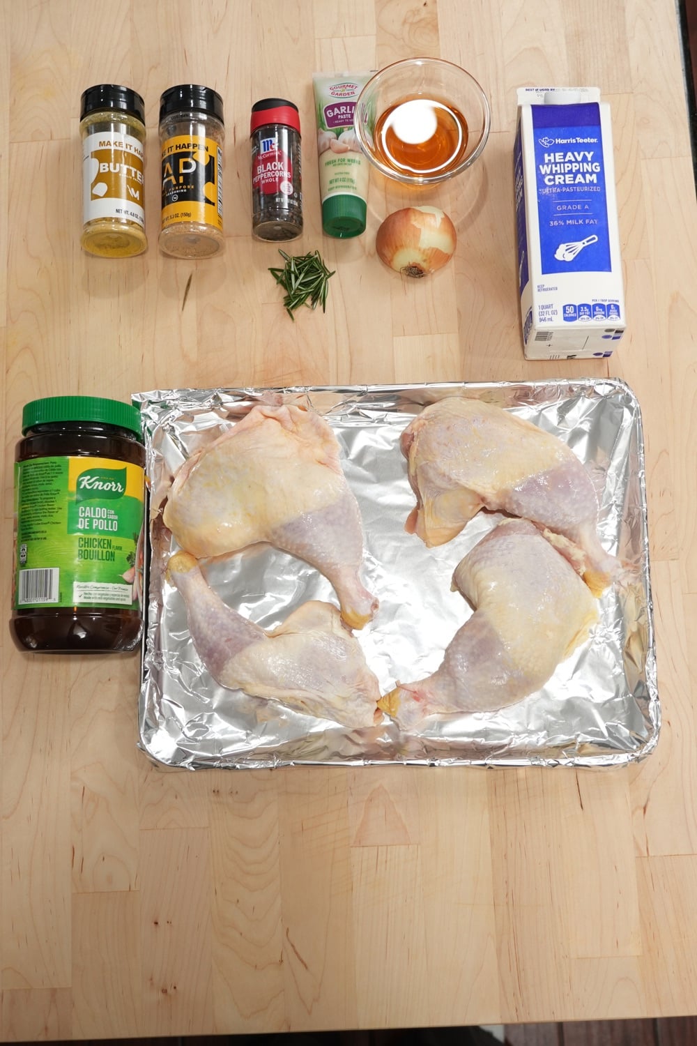 Chicken au poivre ingredients including chicken leg quarters, peppercorns, rosemary, garlic, cream, and cognac
