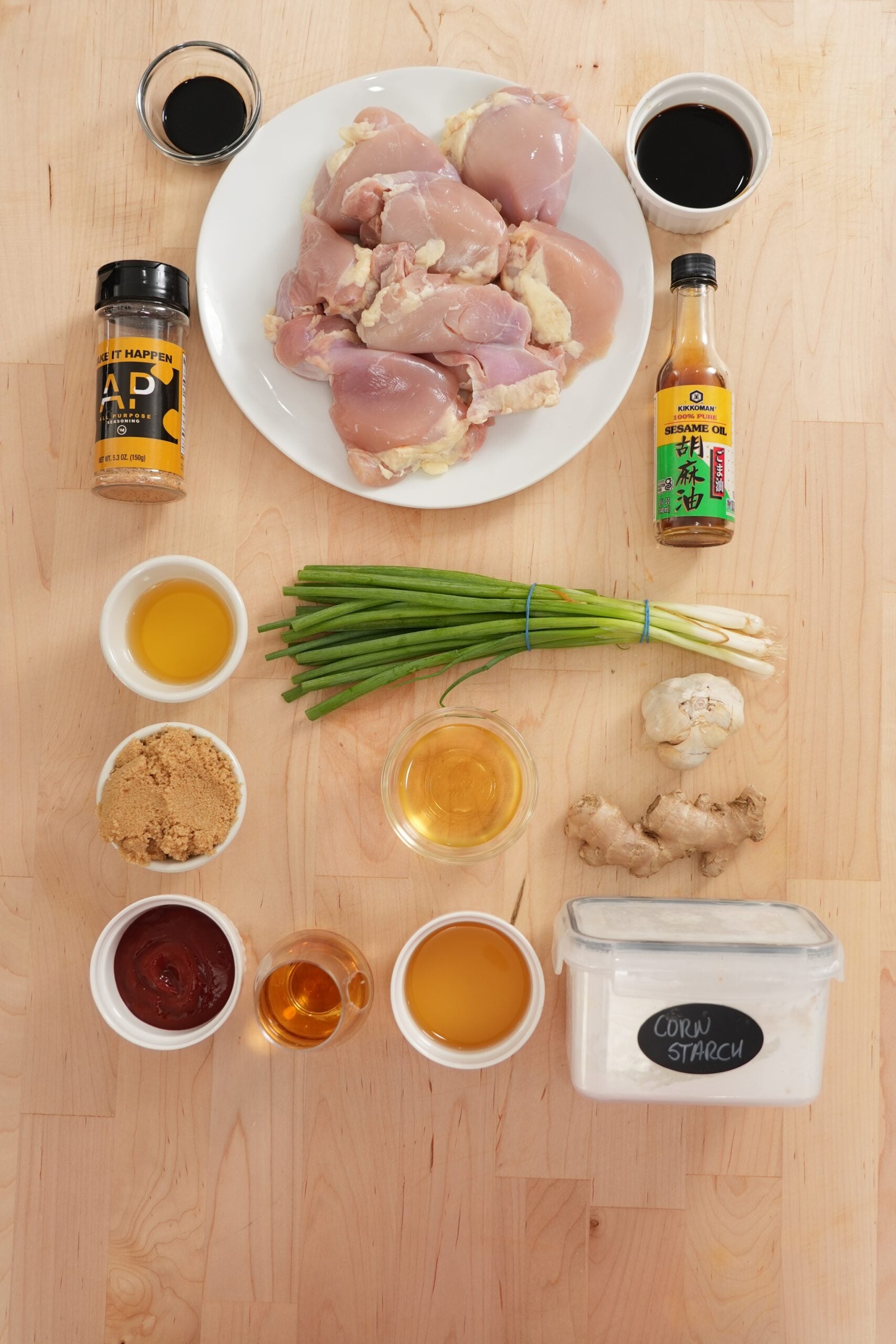 Ingredients for homemade bourbon chicken including chicken thighs, soy sauce and aromatics