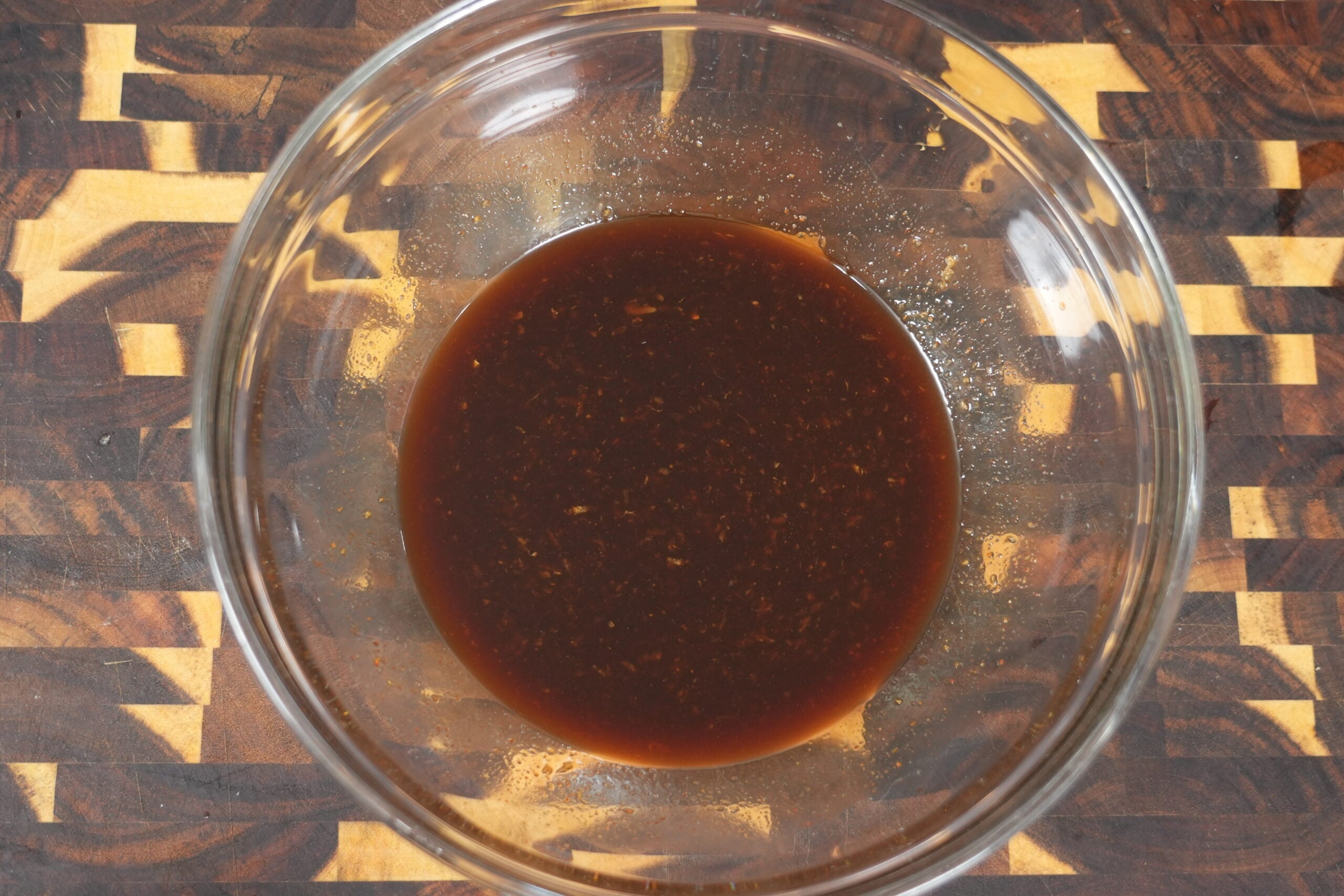 Sticky Asian glaze in a bowl ready for the lamb chops