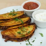 Crispy beef tacos served with salsa, sour cream and lime wedges