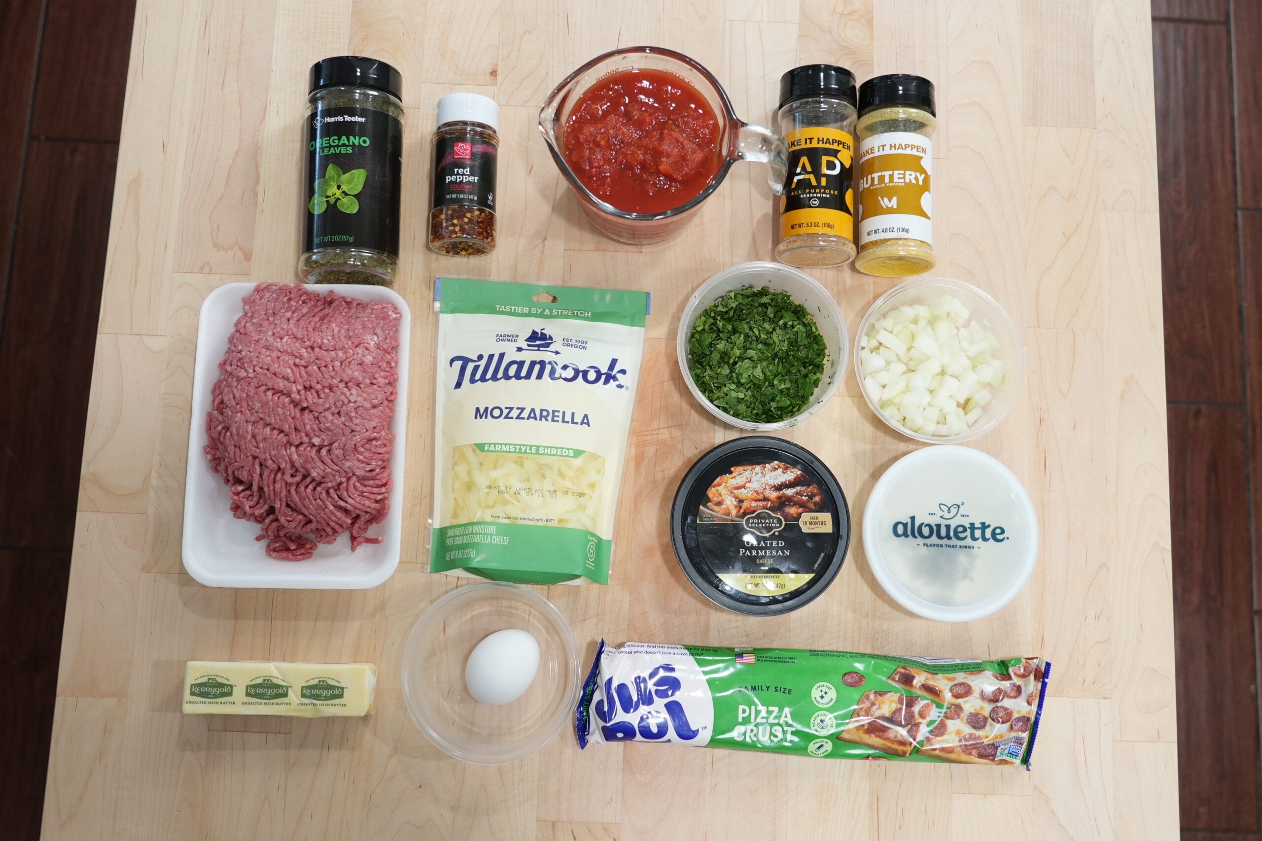 Ingredients for meatball-stuffed garlic knots including ground beef, cheese, pizza dough and tomatoes
