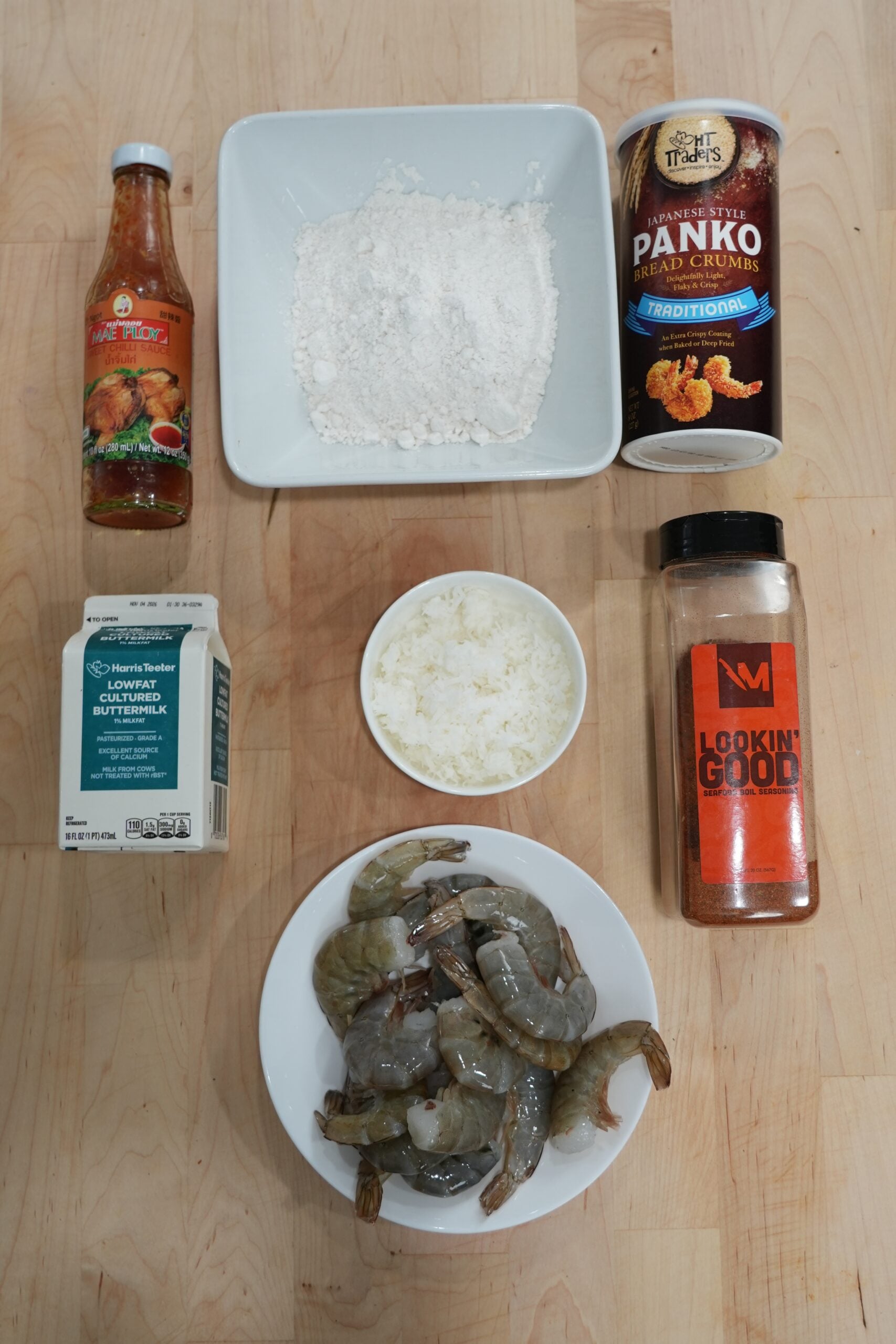 Ingredients for coconut shrimp including shrimp, buttermilk, coconut and panko