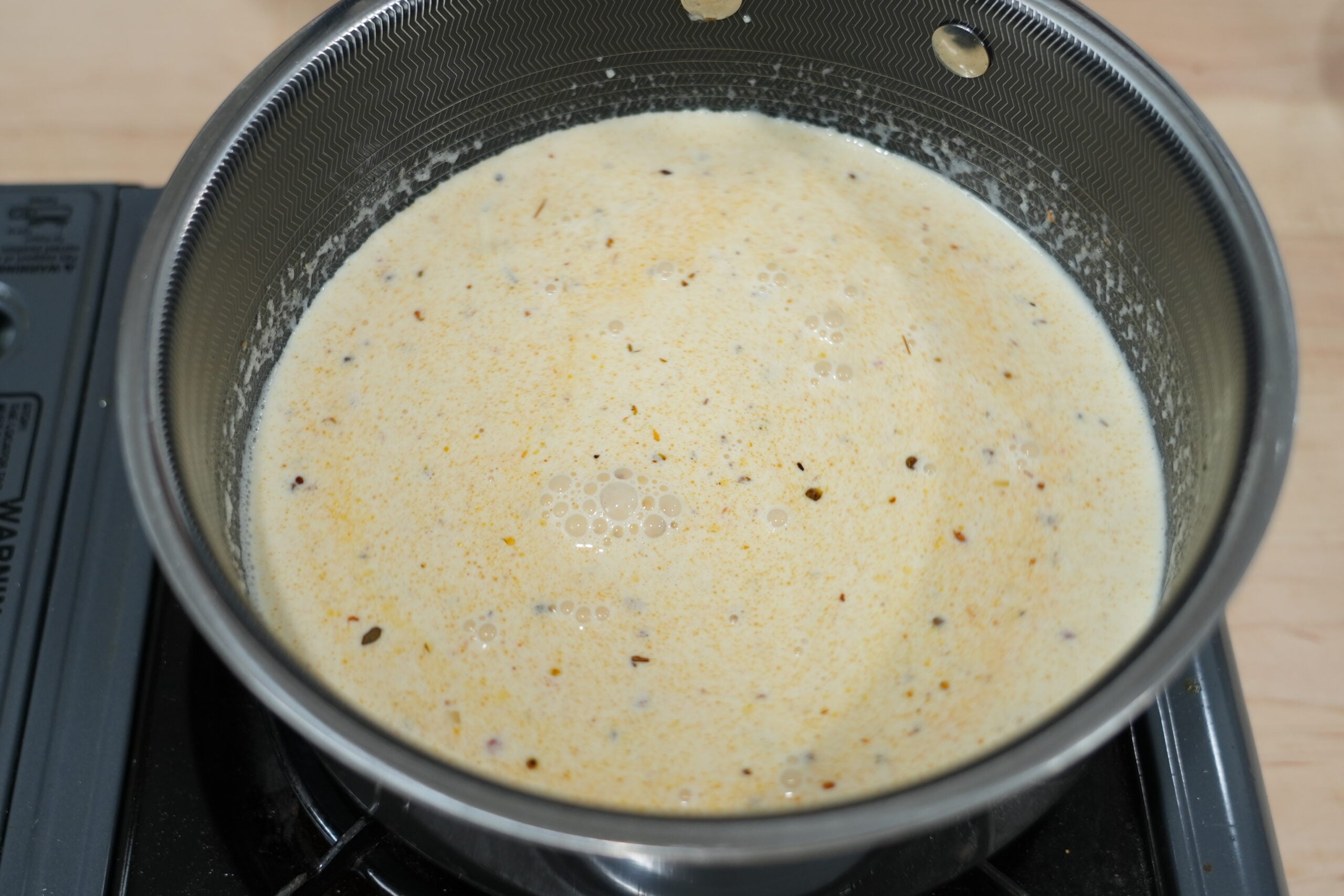 Creamy Cajun Parmesan sauce simmering in a skillet