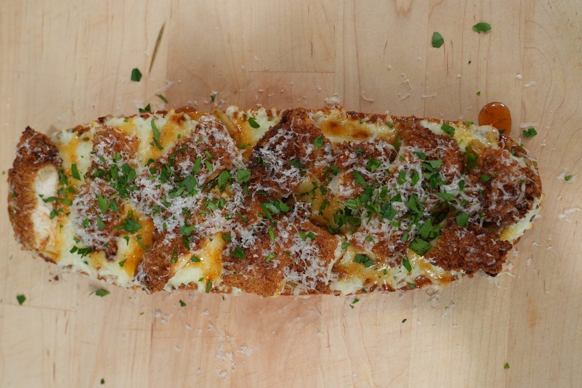 Finished hot honey chicken garlic bread topped with crispy chicken and melted mozzarella
