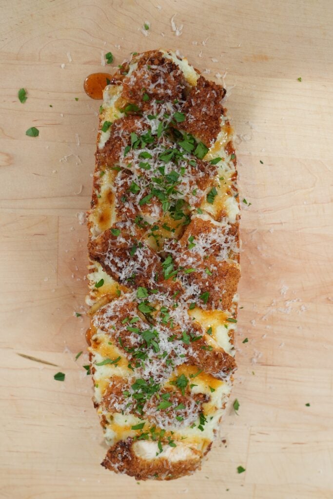 Hot honey chicken garlic bread with crispy chicken, mozzarella and spicy honey drizzle